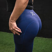 Girl showing side profile of the Navy BBPM Revamped Leggings 