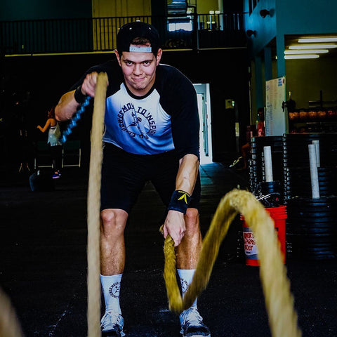 Man using battle ropes wearing the BBPM Agile Raglan Athletic T-Shirt