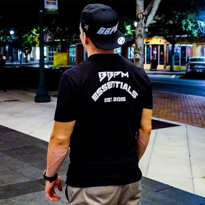 Man showing the back of the black Essentials Athletic T-Shirt